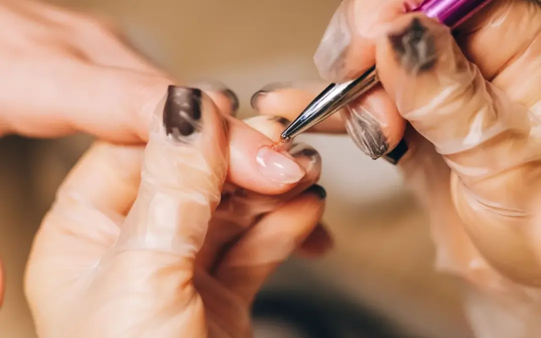 A nail technician working at the CHAIR nail table